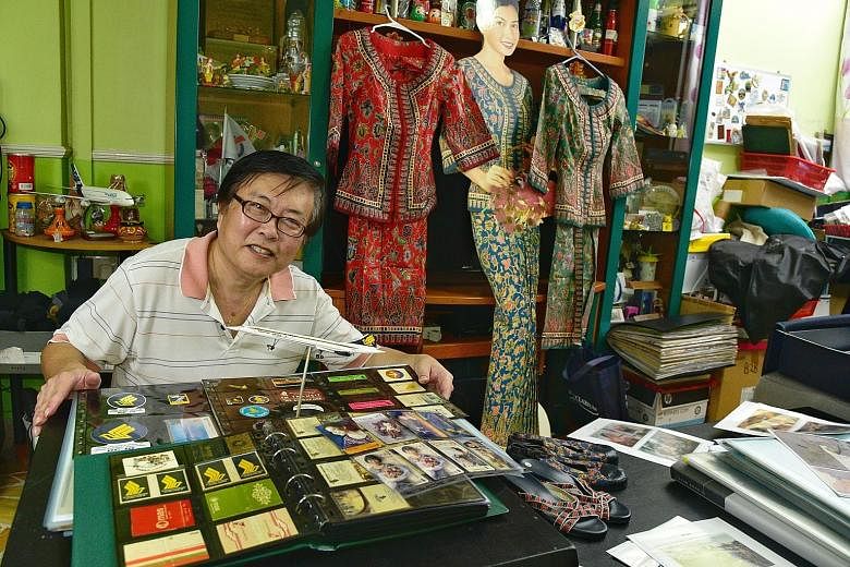 Mr Eddie Yong started his collection of SIA memorabilia, seen here in his Toa Payoh flat, after being inspired by an exhibition in 1997. His pocket albums are filled with phone cards, stickers and matchboxes.