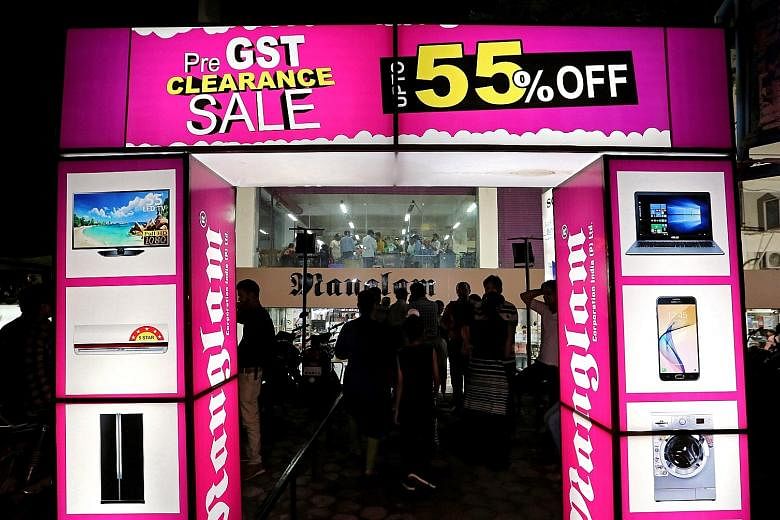 A pre-GST clearance sale at a showroom in Bhopal last Friday. Dealers all over India offered huge discounts before the Goods and Services Tax (GST) was implemented. The unified tax is expected to boost manufacturing, facilitate the movement of goods 
