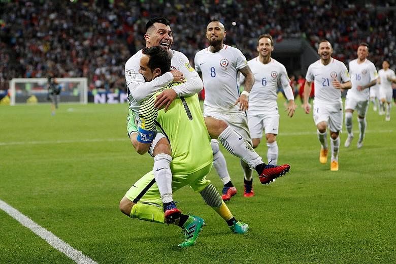 Gary Medel leaps into Claudio Bravo's arms after the Chilean goalie saved three penalties to seal victory against Portugal. Bravo's children always expect him to bring home silverware.