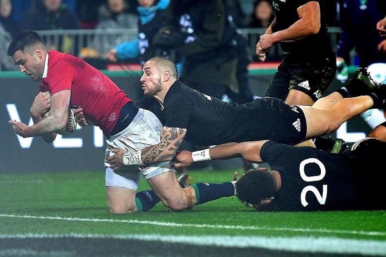 Above: Sonny Bill Williams of the All Blacks tackles the British and Irish Lions' Anthony Watson during the second Test in Wellington yesterday. Williams was red-carded for the shoulder charge against Watson, becoming the first All Black in 50 years 