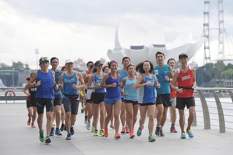 Above: ST Run participants preparing for the July 16 event by taking part in a 15km training run. Left: Dr Lim Kay Kiat giving tips to participants of the ST Run clinic on how to stay injury-free. Fellow orthopaedic specialist Dr Andy Wee (back, left