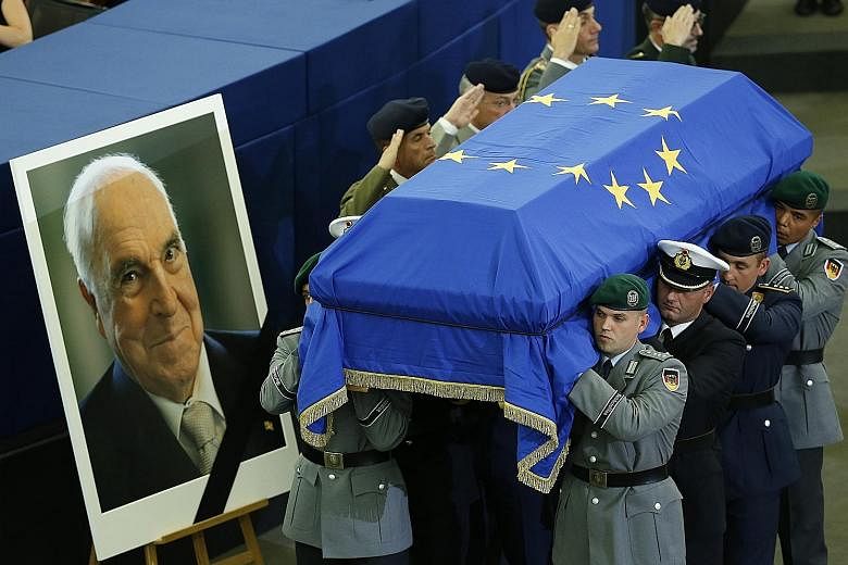 German servicemen carrying the coffin of former chancellor Helmut Kohl during a memorial at the European Parliament in Strasbourg, France, yesterday. The European Union flag of 12 gold stars on a blue background draped his coffin, which was placed in