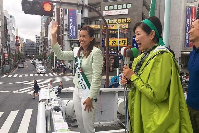 Tokyo Governor and head of Tomin First no Kai party Yuriko Koike taking her message to voters yesterday. Beside her is a candidate from the party, Ms Airi Ryuen, 40, a naturalised Japanese citizen born in Sweden.