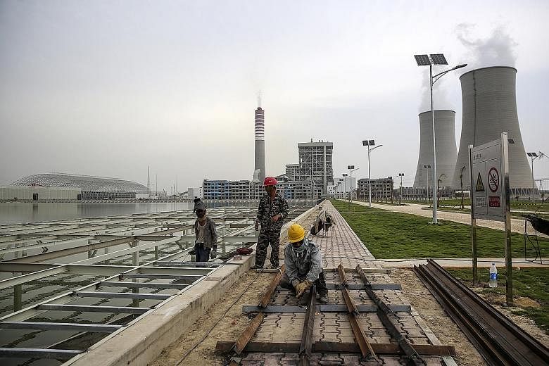 Workers at the Sahiwal coal power plant, owned by China's state-owned Huaneng Shandong Rui Group, in Sahiwal, Punjab, Pakistan. Much of China's overseas push has come under the Belt and Road initiative.