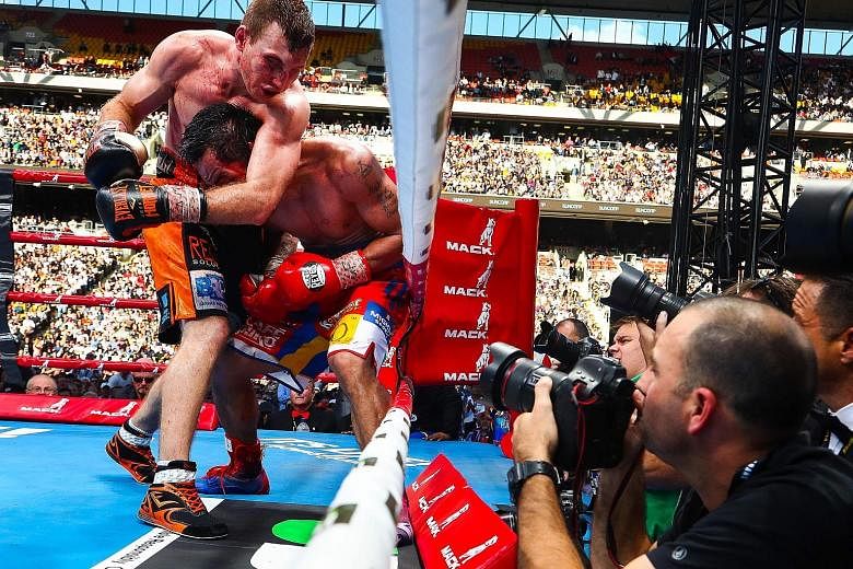 Filipino boxer Manny Pacquiao and Australian Jeff Horn trading punches at Brisbane's Suncorp Stadium. The ex-school teacher remains undefeated with a 17-0-1 record.