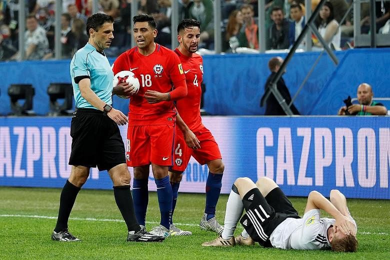 Referee Milorad Mazic ended up cautioning Chile's Gonzalo Jara (No. 18) after a video review of his challenge on Germany's Timo Werner.