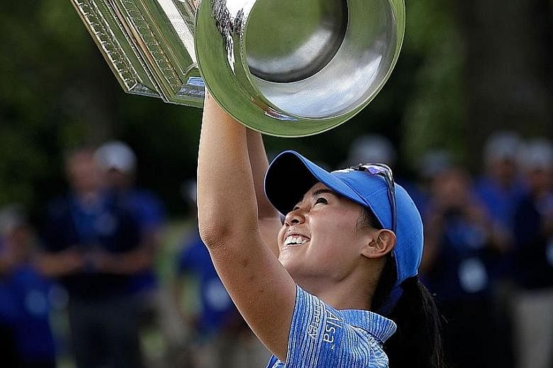 Danielle Kang hoisting the KPMG Women's PGA Championship trophy following her victory at Olympia Fields on Sunday. She defeated Canadian Brooke Henderson, who won the tournament last year, by a single stroke.