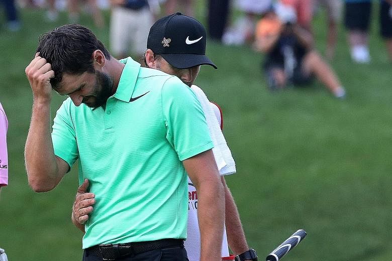 Kyle Stanley of the United States finding it hard to control his emotions while being congratulated by his caddie Bryan Reed after making a par putt on the first play-off hole to win the PGA National on Sunday.