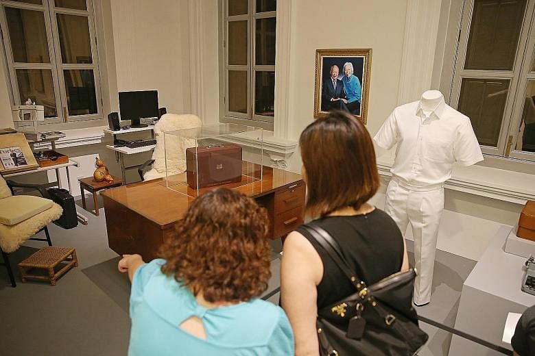Guests at a preview of We Built A Nation, an exhibition at the National Museum of Singapore in 2015. Some of the late Mr Lee Kuan Yew's personal effects on display then included a writing table from Oxley Road and a red box he used to keep his workin