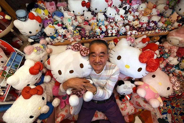 Retired Japanese police officer Masao Gunji posing with his Hello Kitty collection at his pink-painted Hello Kitty house in Yotsukaido, Chiba prefecture. Mr Gunji was recognised for having the largest Hello Kitty collection - 5,169 items - by the Gui