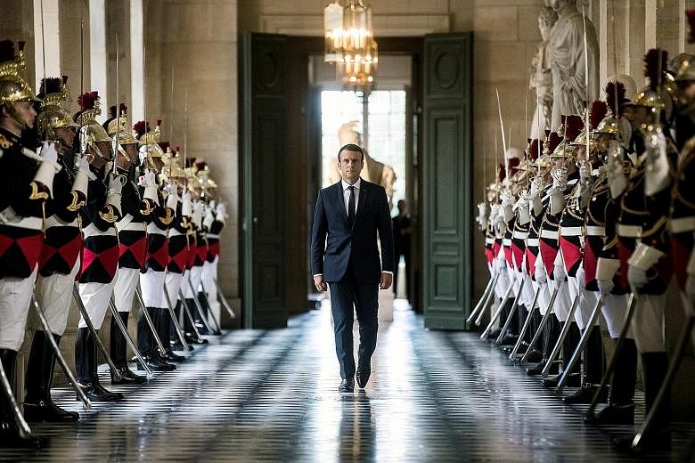 French President Emmanuel Macron on his way to meet lawmakers at Versailles Palace on Monday. By meeting at the 17th-century palace built by the "Sun King", Mr Macron was seeking to restore old-fashioned grandeur to the role.