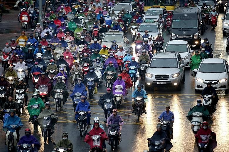 Vehicles on a congested road in Hanoi, Vietnam, last Thursday. The decision to ban the two-wheelers in the capital city, which has around five million motorcycles and 500,000 cars spread among a population of about seven million, was approved by 95 o