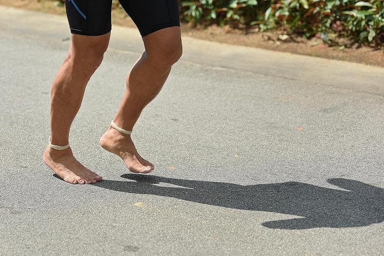 Avid runner Peter Loong running barefoot, which involves him landing on the balls of his feet first, instead of his heels.