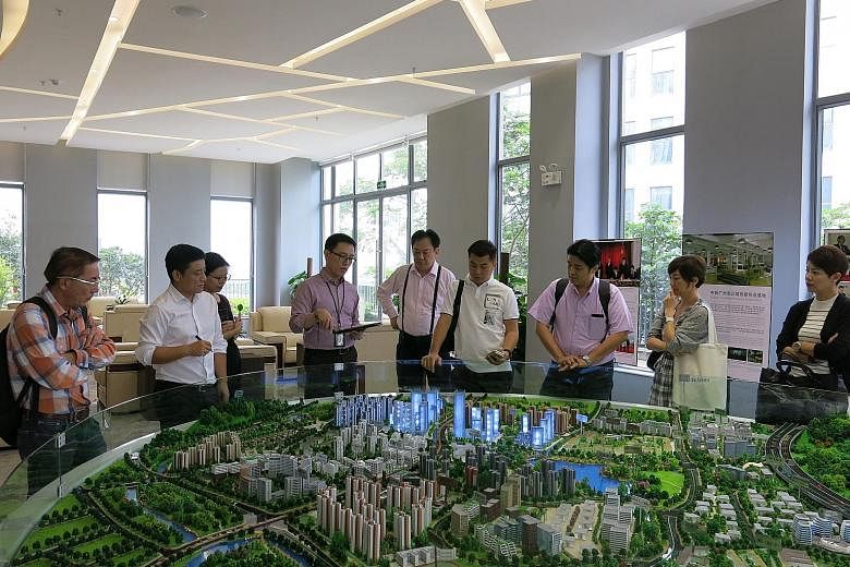 Participants of the China Ready Programme viewing a model at Guangzhou Knowledge City. The new programme, which is aimed at helping small and medium-sized enterprises break into the Chinese market, saw a total of six Singapore companies from sectors 