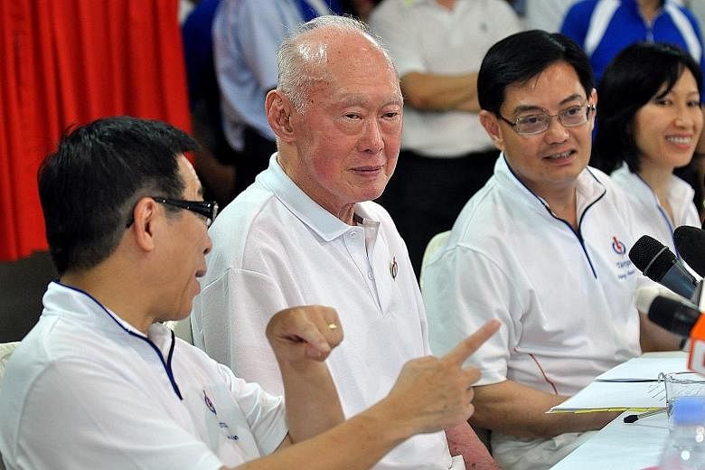 Mr Lee Kuan Yew, then Minister Mentor, speaking to residents of Tampines GRC in 2011. With him is Mr Heng Swee Keat, who was Mr Lee's principal private secretary from 1997 to 2000.