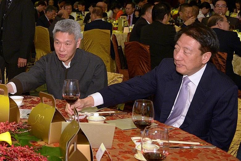 Mr Lee Hsien Yang and Mr Teo Chee Hean at a Business China dinner celebrating Mr Lee Kuan Yew's 90th birthday. The younger Mr Lee represented his father at the dinner.