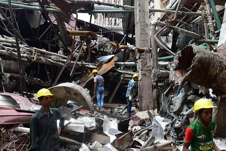 Bangladeshi workers taking part in a search and rescue operation at a destroyed garment factory in Gazipur on Tuesday after a boiler explosion at the complex on the outskirts of Dhaka that killed 13 people and injured dozens. Police have filed charge