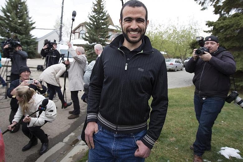 Mr Omar Khadr leaving a news conference after being released on bail in Edmonton, Alberta, in May 2015. Mr Khadr, a Canadian, was captured in Afghanistan in 2002 at age 15 and was the youngest prisoner at Guantanamo Bay.