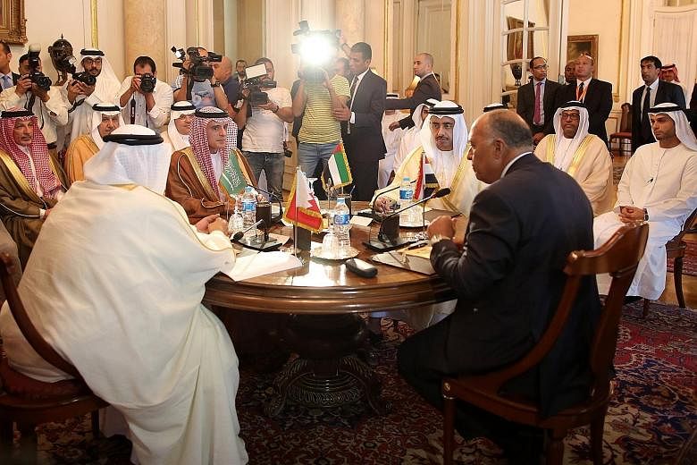 Seated at the table (clockwise, from left) are Bahrain Foreign Minister Khalid bin Ahmed al-Khalifa, Saudi Foreign Minister Adel al-Jubeir, UAE Foreign Minister Abdullah bin Zayed al-Nahyan and Egyptian Foreign Minister Sameh Shoukry. They met in Cai