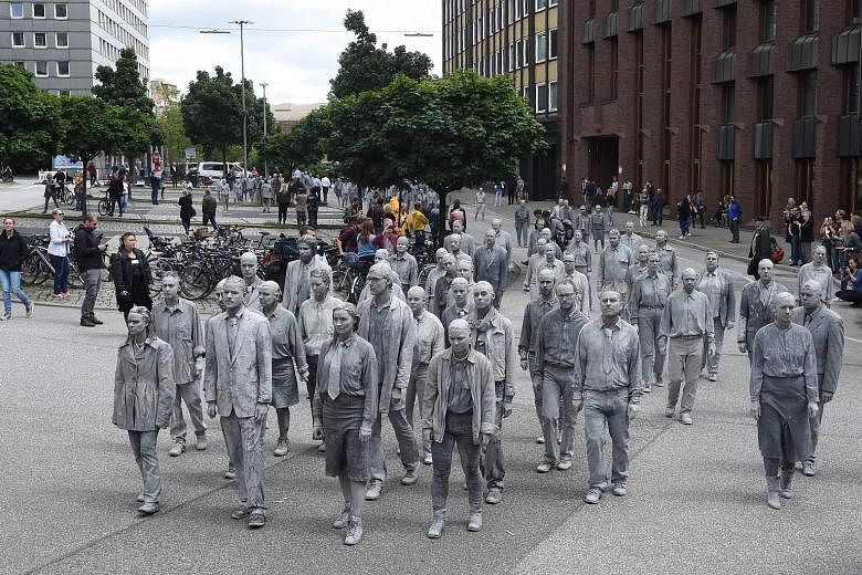 About 20,000 police will be guarding world leaders at the G-20 summit as up to 100,000 protesters, such as the anti-capitalist demonstrators smeared with clay during the 1,000 Gestalten performance, are expected to march in about 30 rallies in Hambur