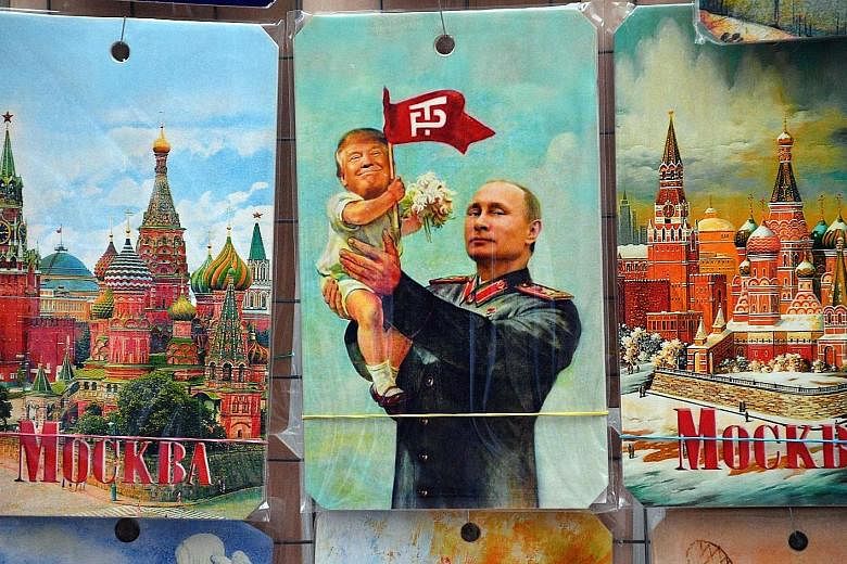 A drawing on sale in a souvenir shop in Moscow depicting Russian President Vladimir Putin holding a baby with the face of US President Donald Trump, based on an old propaganda poster showing former Soviet leader Joseph Stalin holding a baby. The firs