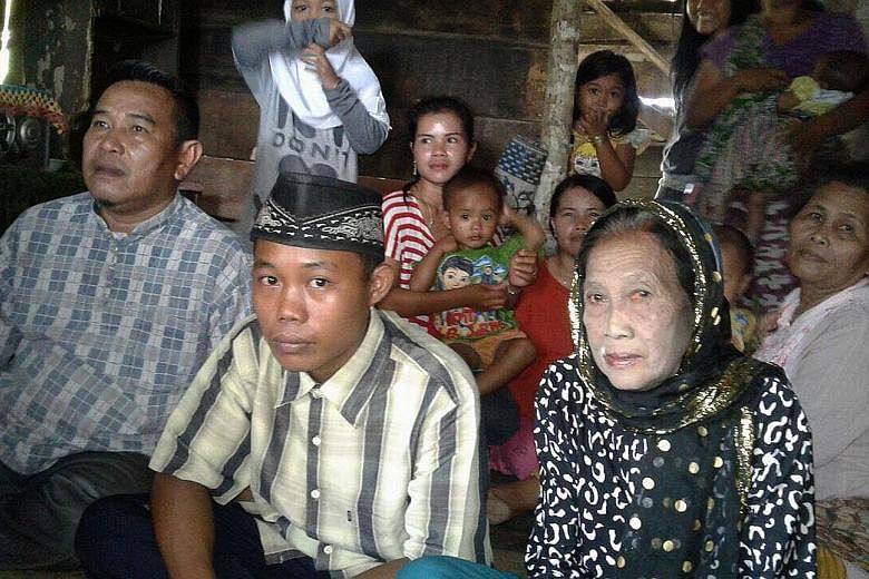 Selamet Riyadi, 15, and his 73-year-old bride Rohaya Binti Kiagus Muhammad Jakfar, who took care of him when he was suffering from malaria. Local officials allowed the marriage after the couple threatened a double suicide.
