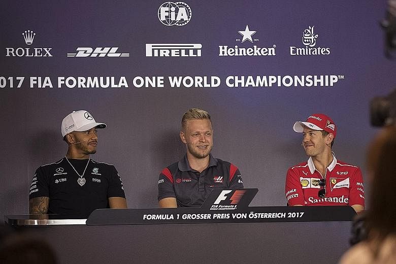 From left: Mercedes' Lewis Hamilton, Haas' Kevin Magnussen and Ferrari's Sebastian Vettel are all smiles at a drivers' press conference ahead of the Austrian Grand Prix this weekend.