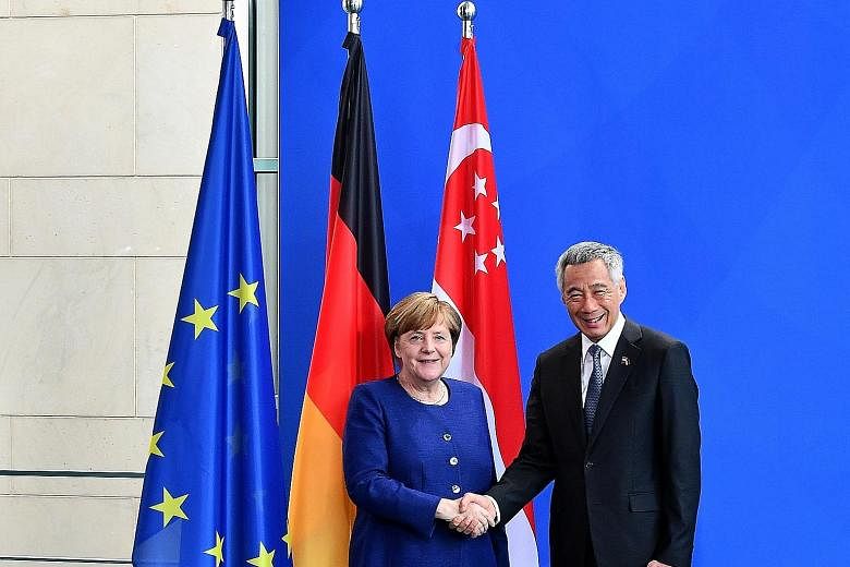 Prime Minister Lee Hsien Loong with Chancellor Angela Merkel at the Federal Chancellery in Berlin yesterday. PM Lee said he is very happy that both countries have strengthened their cooperation since his last visit in 2015, for the 50th anniversary o