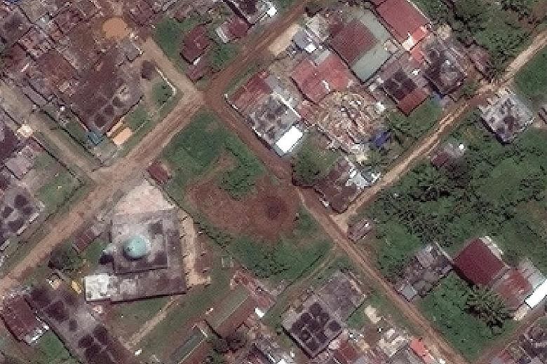 Left: The Masjed Mindanao Islamic Centre stands intact even as much of the surrounding area has been flattened, in what could be a deliberate move by the authorities. It is believed militant leader Isnilon Hapilon is hiding there, surrounded by hosta