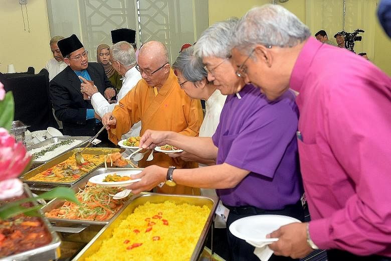At yesterday's event are (from left at table) Mufti Fatris Bakaram, Inter-Religious Organisation president and Parsi Zoroastrian Association president Rustom Ghadiali, Buddhist Federation president Seck Kwang Phing, Roman Catholic Church's Sister Mar