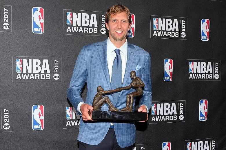 Dallas Mavericks star Dirk Nowitzki poses with his Teammate of the Year award during the inaugural NBA Awards show.