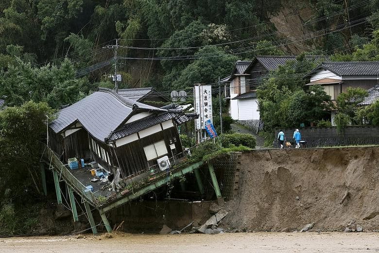 Many people were still unaccounted for yesterday following severe flooding across wide swathes of Japan's south-western main island of Kyushu, which continued to be battered by torrential rain. 	At least six people have died and a massive search and 