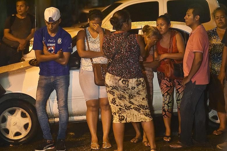 Relatives of inmates awaiting news of their loved ones outside the district attorney's office in Acapulco, Mexico, on Thursday after a riot left 28 inmates dead. State police have temporarily taken control of the prison, backed by federal police and 
