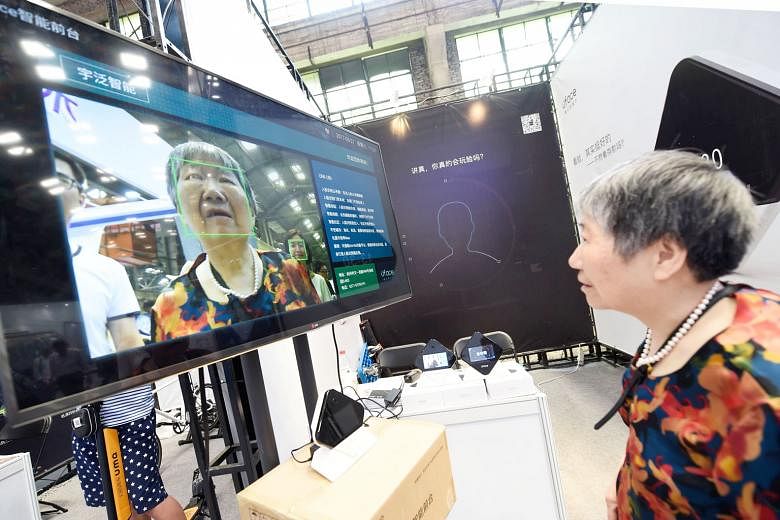 A woman looking at a screen displaying facial-recognition technology at the Hangzhou International Future Life Festival exhibition in May. Facial-recognition cameras are being used in China for routine activities such as withdrawing cash from an ATM,