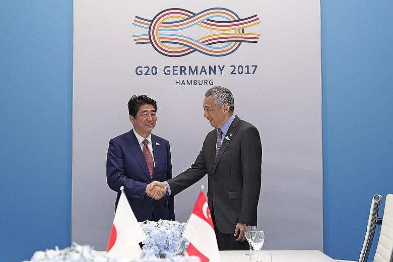 Prime Minister Lee Hsien Loong meeting Japanese Prime Minister Shinzo Abe yesterday.