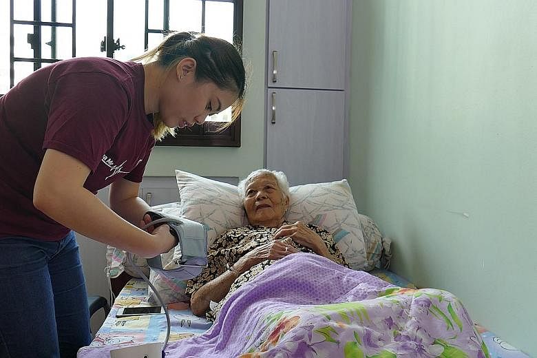 A Jaga-Me home care nurse assisting a patient in Bukit Panjang. The social enterprise charges $550 a day for 24-hour care, but recently started Project Going Home to offer free nursing services to financially needy patients who have been given a term