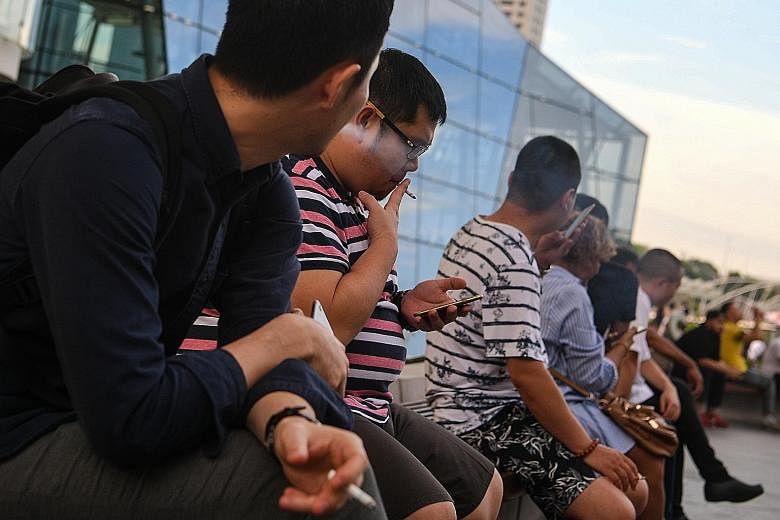 People having a smoke at Marina Bay Sands. There has been a number of changes to Singapore's anti-smoking policies as the Government seeks to get people to quit the habit. Although the number of adults smoking fell progressively from 23 per cent in 1