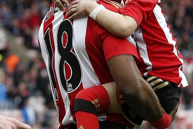 Sunderland's Jermain Defoe walks out with Bradley Lowery before the match against Swansea City on May 13. The six-year-old's death was announced by his family on Friday. His plight touched people all round the world and he received 250,000 Christmas 