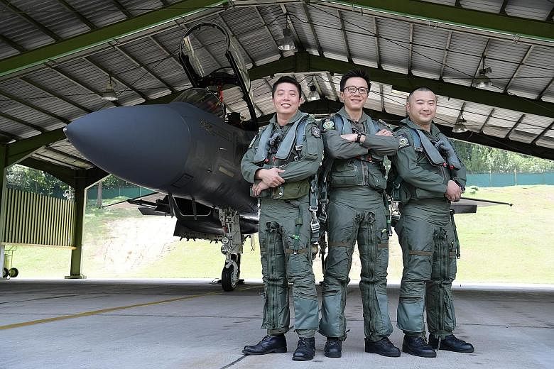 Senior Lieutenant-Colonel Goh Sim Aik (centre), mission lead of the NDP 2017 aerial salute, with the two operationally ready national servicemen pilots - Captain (NS) Valent Tan (left) and Major (NS) Timothy Siah.