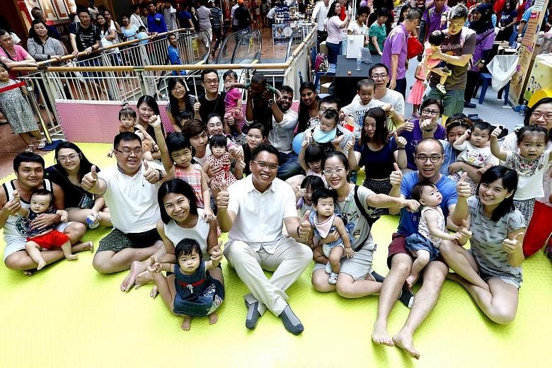 Mr Patrick Tay (centre), adviser to Boon Lay grassroots organisations, with parents at the programme's launch yesterday.