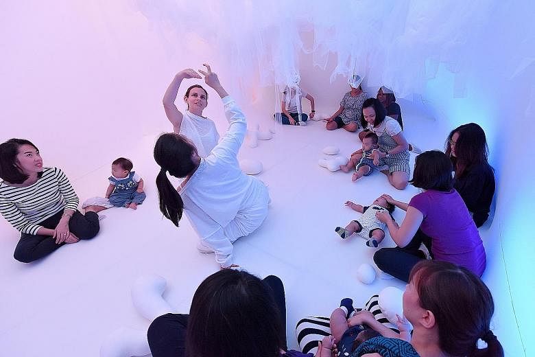 Ms Wang Tingting and her nine-month-old daughter Sophie Wiranata explore Baby Space (above), an installation designed for babies aged 16 months and below.