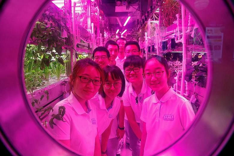 Student volunteers looking out of the window of a simulated space cabin that they will call home for the next 200 days. The 160 sq m Lunar Palace is part of a project at Beijing's Beihang University that aims to simulate a long-term, self-contained s