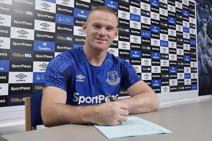 Forward Wayne Rooney is all smiles after sealing his return to boyhood club Everton on a two-year deal.