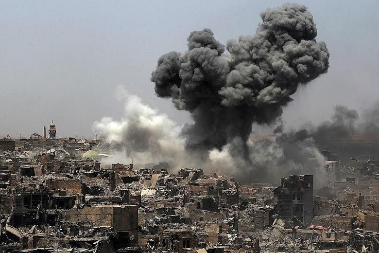 An air strike by US-led coalition forces in Mosul yesterday. The battle to retake the city from ISIS has left large parts of it in ruins, killed thousands of civilians and displaced nearly one million people. The UN predicts it will cost more than $1