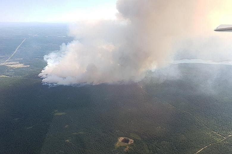 Wildfires seen near 100 Mile House in British Columbia. The spate of wildfires began last Friday, when 138 new fires were reported, most of them sparked by lightning in dry electrical storms.