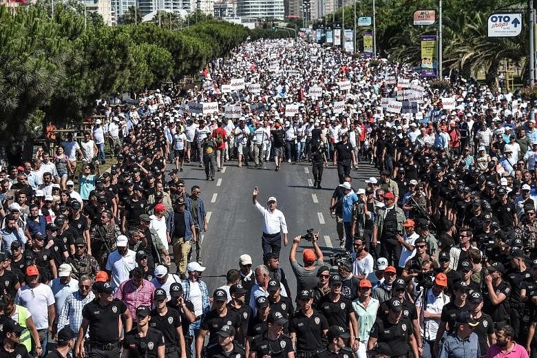 Supporters of Republican People's Party leader Kemal Kilicdaroglu (centre) walk alongside him on the 24th day of the march for justice in Istanbul on Saturday.