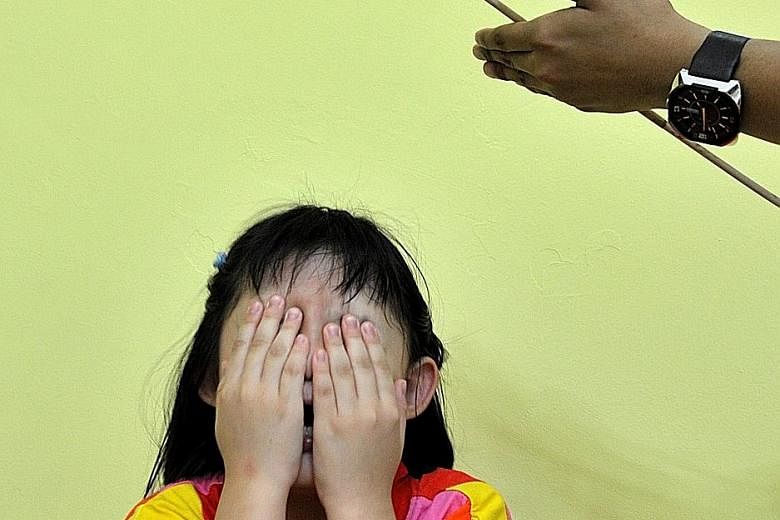 Posed photo of a girl crying at the sight of a cane. Constant fear of the cane can tip a child into anxiety and depression. 