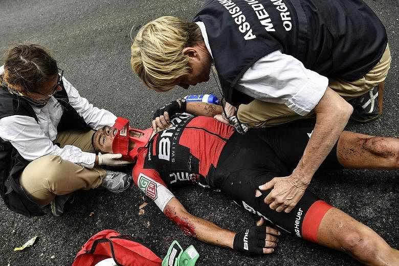 Richie Porte receives medical assistance after falling during the ninth stage of the Tour. The Australian broke his collarbone and pelvis descending Mont du Chat.
