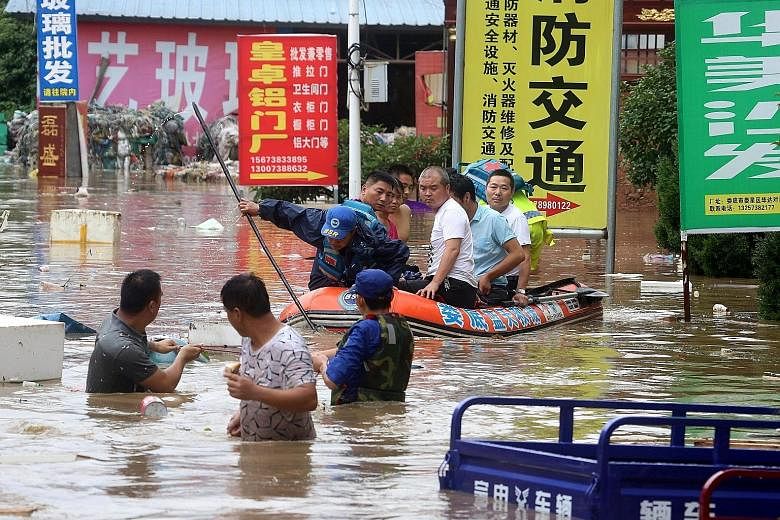 People being evacuated from a flooded area in Loudi city, Hunan province, on July 1. Days of downpours have brought floods to vast areas in southern China.