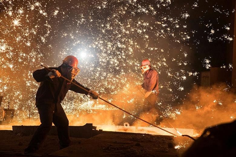 Workers at Shandong Iron and Steel Group's plant in Jinan, Shandong province. Even as inflation steadies on weaker commodity prices, regulatory curbs on excessive borrowing may erode momentum later this year.